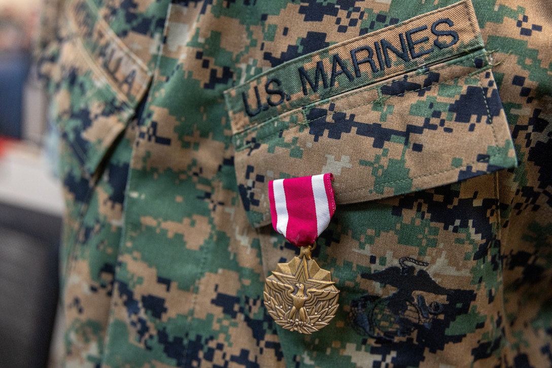 U.S. Marine Corps awards Master Sgt. Andres Moratalla, theater security cooperation operations chief with Marine Forces South, the Meritorious Service Medal by the 39th Commandant of the Marine Corps, Gen. Eric Smith, at Marine Corps Support Facility New Orleans, July 17, 2025. Smith visited New Orleans to recognize the Marines and staff who dedicate their time and efforts to the MARFORRES and MARFORSOUTH missions. (U.S. Marine Corps photo by Cpl. Aaron TorresLemus)