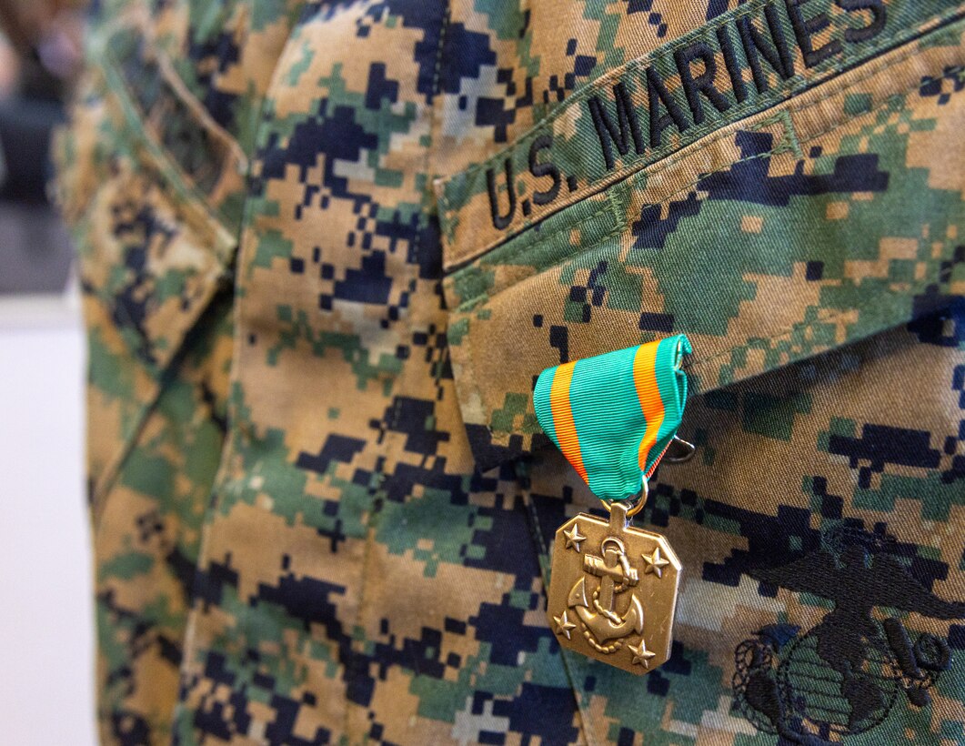U.S. Marine Corps Sgt. Derek McCutchon, command center and mobilization watch staff non-commissioned officer with Headquarters Battalion, Marine Forces Reserve, is awarded the Navy Achievement Medal by the 39th Commandant of the Marine Corps, Gen. Eric Smith, at Marine Corps Support Facility New Orleans, July 17, 2025. Smith visited New Orleans to recognize the Marines and staff who dedicate their time and efforts to support the MARFORRES and MARFORSOUTH missions. (U.S. Marine Corps photo by Cpl. Aaron TorresLemus)