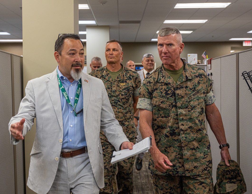 Mr. Todd Fujimoto (left), Marine Forces Reserve and Marine Forces South G-4 deputy assistant chief of staff, escorts Gen. Eric Smith (right), 39th Commandant of the Marine Corps, through logistics operations at Marine Corps Support Facility New Orleans, July 17, 2025. Smith visited New Orleans to recognize the Marines and staff who dedicate their time and efforts to support the MARFORRES and MARFORSOUTH missions. (U.S. Marine Corps photo by Cpl. Aaron TorresLemus)