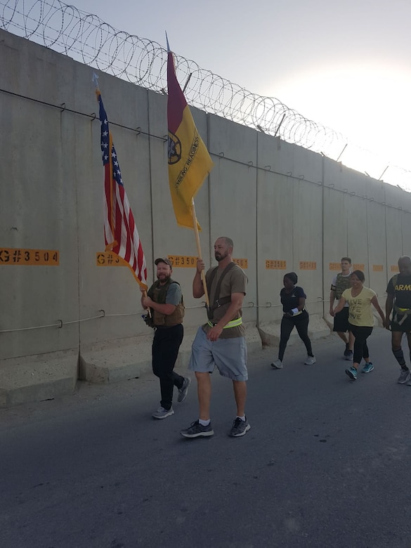 U.S. Army Corps of Engineers civilian contracting officer technical representative, Ryan Williams, joins fellow government employees in a team-building walk around the perimeter of Bagram Airfield, Afghanistan, on Sept. 11, 2020. Participants carried the U.S. flag during the 13-mile trek around the country's largest U.S. military base to mark the anniversary of the 9/11 attacks. (U.S. Army Photo by Ryan Williams)