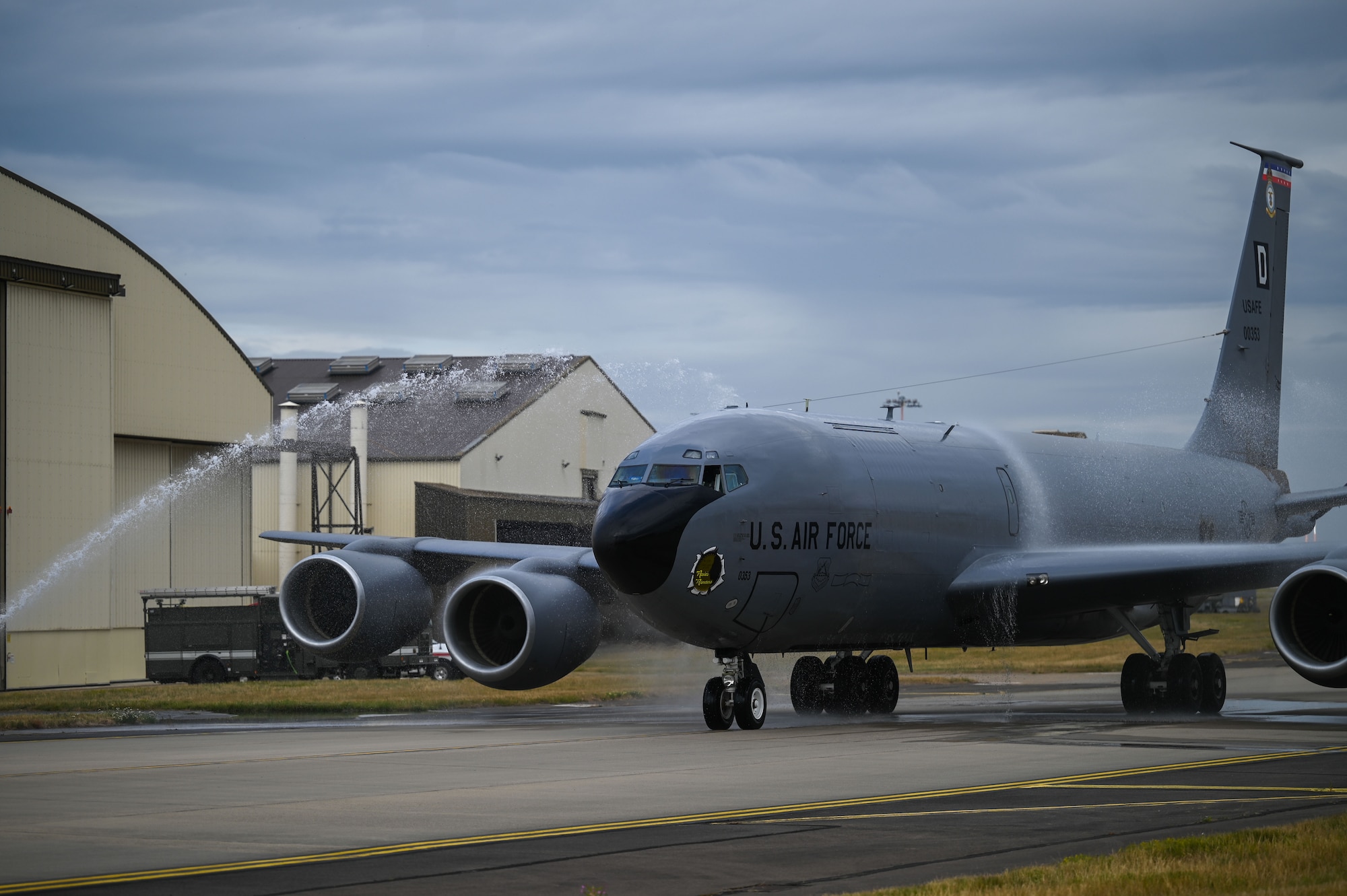 U.S. Air Force Col. Ryan Garlow, 100th Air Refueling Wing commander, pilots a KC-135 Stratotanker through an archway of water after his fini-flight at RAF Mildenhall, England, July 17, 2025.