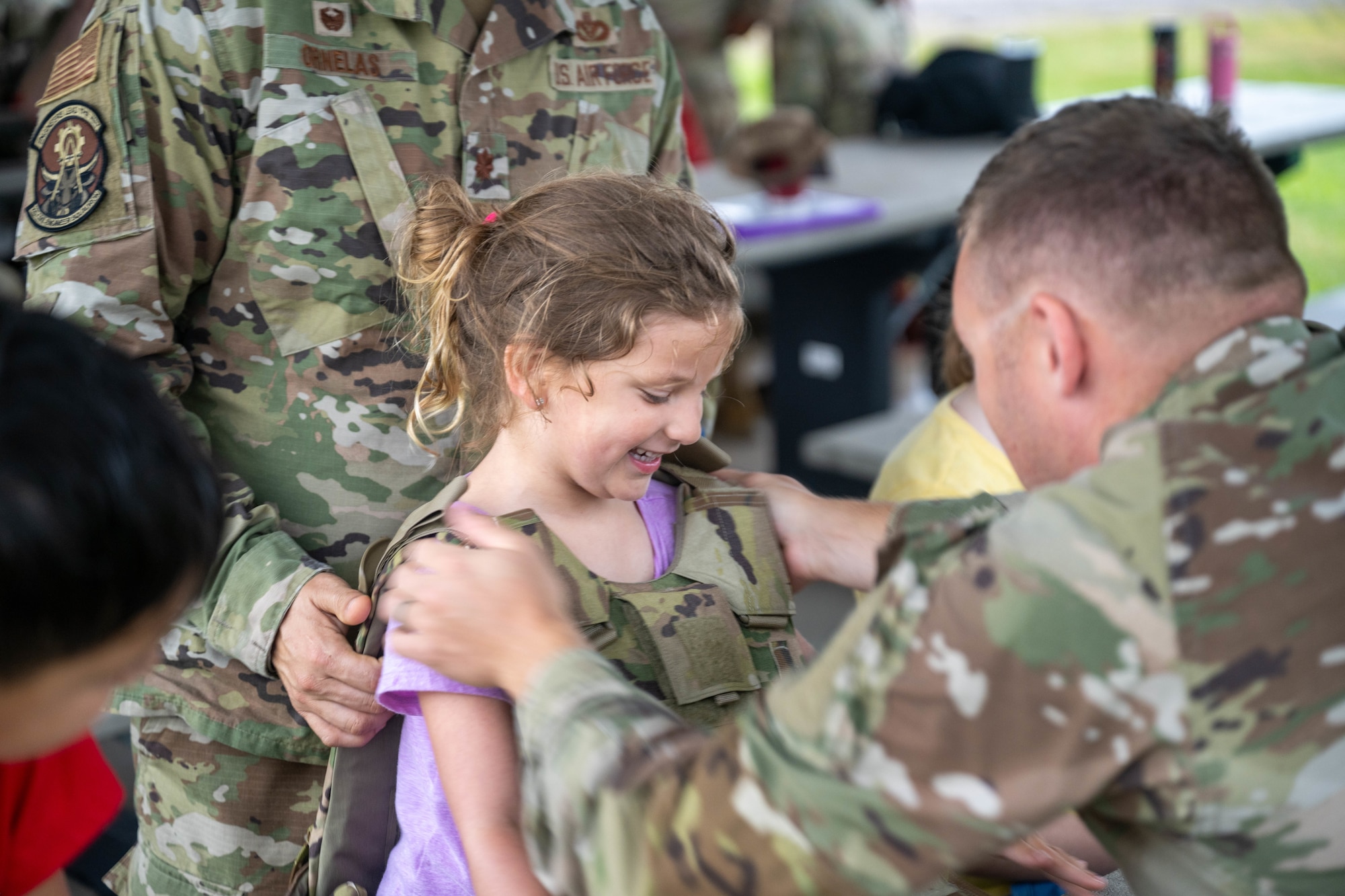 A child wears a plate carrier.