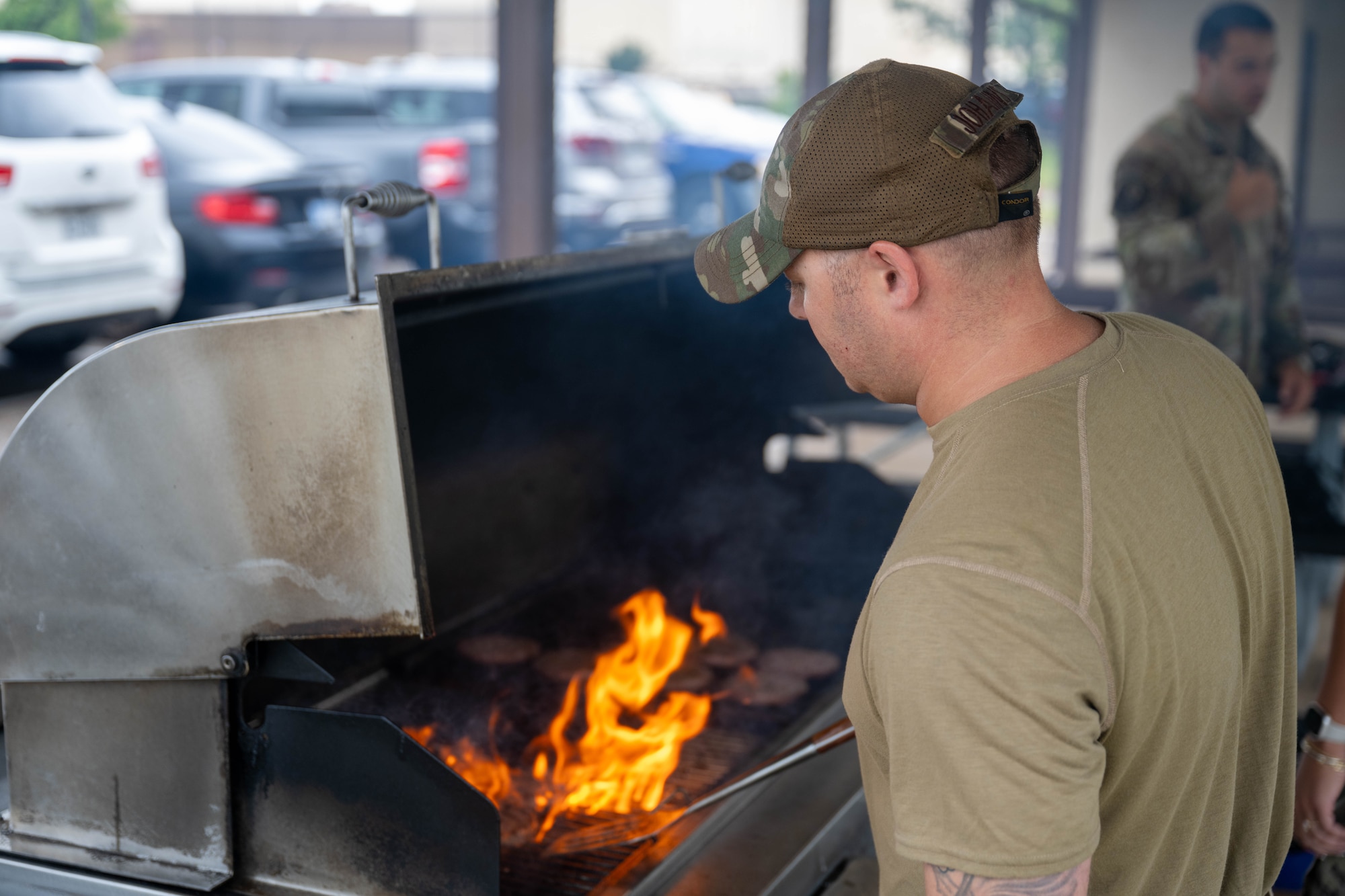 A man cooks on a grill.