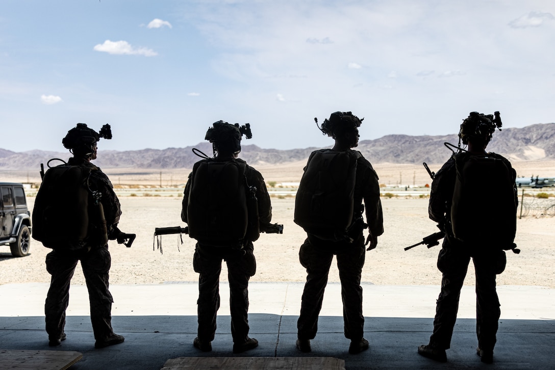 U.S. Marines with 2d Reconnaissance Battalion, 2d Marine Division stage themselves before a freefall jump during Service Level Training Exercise 4-25, on Marine Corps Air-Ground Combat Center, Twentynine Palms, California, July 17, 2025. SLTE 4-25 is designed to be a challenging, realistic training environment that produces combat-ready forces capable of operating as an integrated Marine Air Ground Task Force across all domains of military operations. (U.S. Marine Corps photo by Lance Cpl. Judith Ann Lazaro)