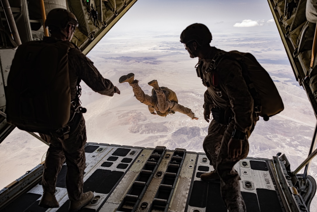 U.S. Marines with 2d Reconnaissance Battalion, 2d Marine Division conduct a freefall jump off a C-130 Hercules during Service Level Training Exercise 4-25, on Marine Corps Air-Ground Combat Center, Twentynine Palms, California, July 17, 2025. SLTE 4-25 is designed to be a challenging, realistic training environment that produces combat-ready forces capable of operating as an integrated Marine Air Ground Task Force across all domains of military operations. (U.S. Marine Corps photo by Lance Cpl. Judith Ann Lazaro)