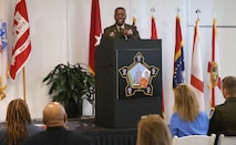 Man speaking at podium.