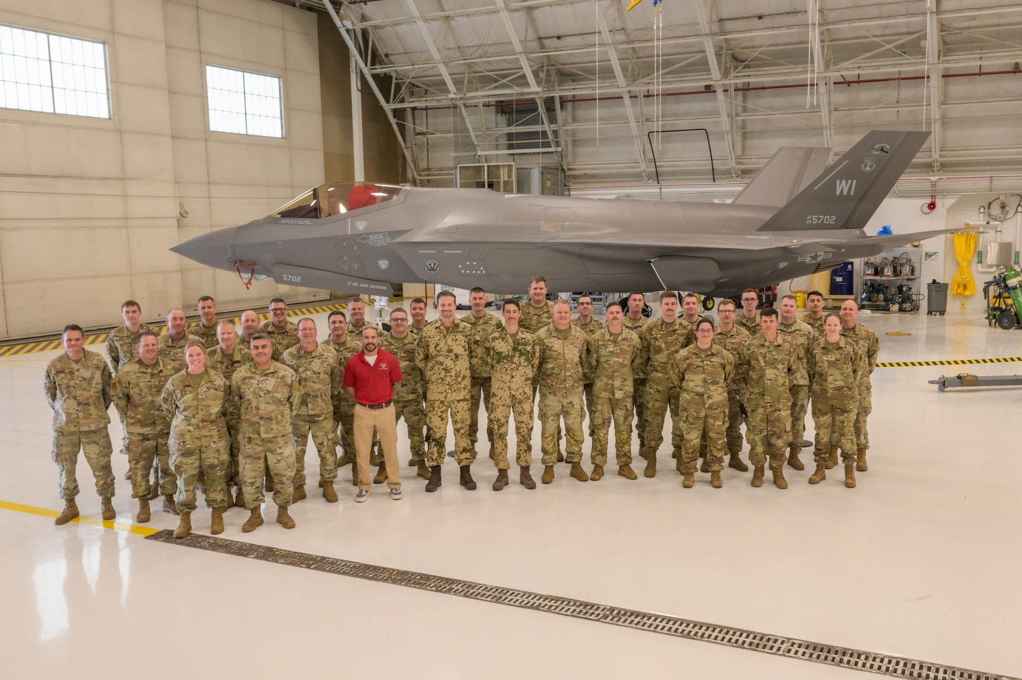 U.S. Airmen assigned to the 115th Fighter Wing, Wisconsin Air National Guard and German Officers pose in front of an F-35 Lightning II aircraft assigned to the 115th Fighter Wing during a visit for the Military Reserve Exchange Program at Truax Field in Madison, Wisconsin, June 12, 2025. The MREP provides an opportunity for professional development by allowing participants to train in a duty assignment similar to wartime. (U.S. Air National Guard photo by Master Sgt. Mary Greenwood)