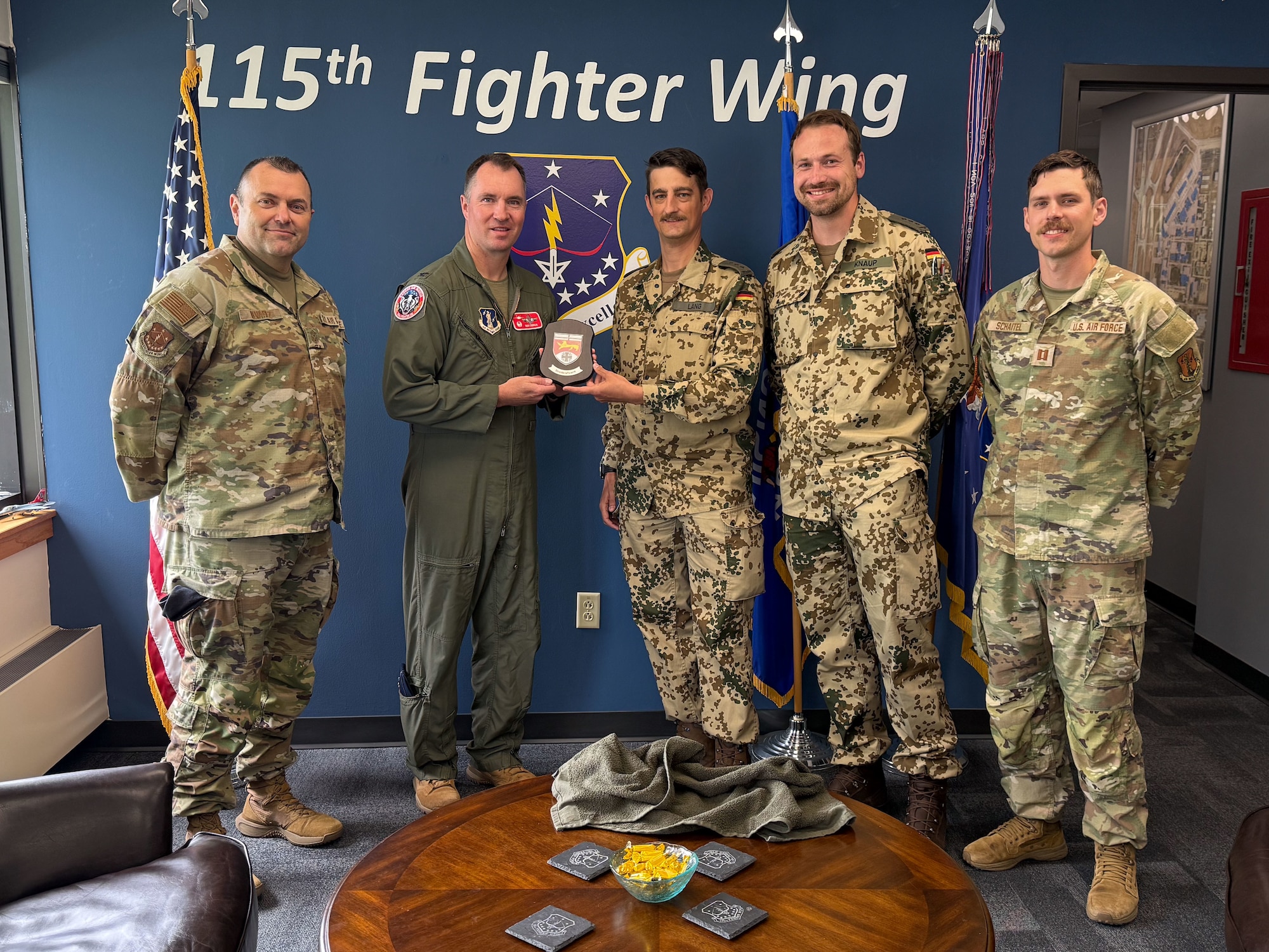 U.S. Air Force leadership assigned to the 115th Fighter Wing, Wisconsin Air National Guard, exchange pleasantries and gifts with German Air Force officers during a meet and greet for the Military Reserve Exchange Program at Truax Field in Madison, Wisconsin, June 9, 2025. The MREP provides an opportunity for professional development by allowing participants to train in a duty assignment similar to wartime. (U.S. Air National Guard photo by Master Sgt. Mary Greenwood)