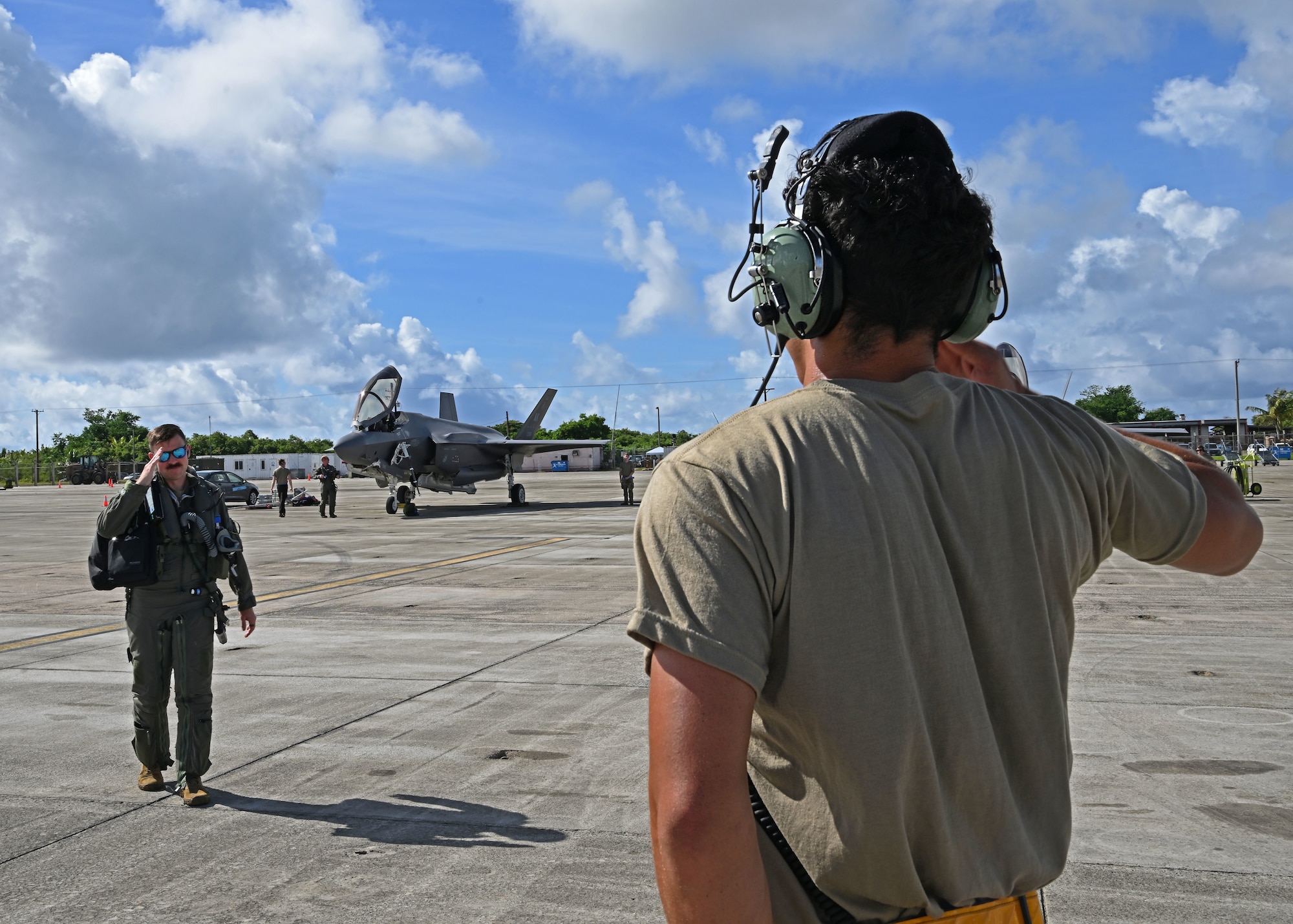 U.S. Air Force Senior Airman Julian Martinez, right, 354th Air Expeditionary Wing assistant dedicated crew chief, salutes U.S. Air Force Lt. Col Erik Gonsalves, 355th Mission Generation Force Element commander, before a flight during exercise Resolute Force Pacific (REFORPAC) 2025, July 17, 2025.