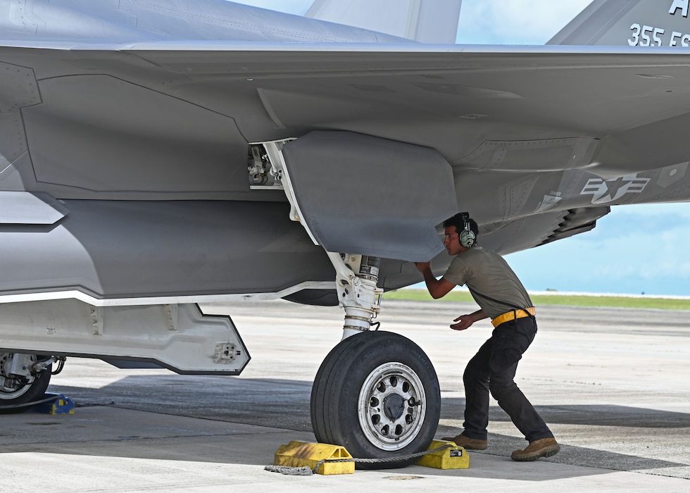 U.S. Air Force Senior Airman Julian Martinez, right, 354th Air Expeditionary Wing assistant dedicated crew chief, inspects an F-35A Lightning II before a flight during exercise Resolute Force Pacific (REFORPAC) 2025, July 17, 2025.