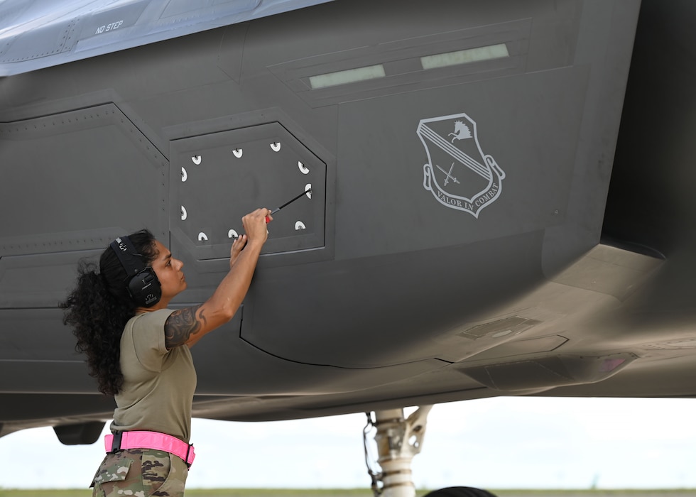 U.S. Air Force Airman 1st Class Ivelisse Lozada Quesada, 354th AEW aircraft armament system weapons, secures a panel on an F-35A Lightning II before a flight during exercise Resolute Force Pacific (REFORPAC) 2025, July 17, 2025.