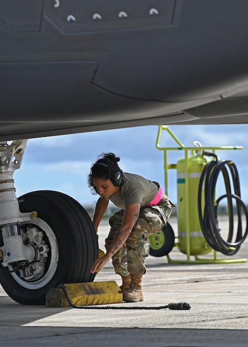 U.S. Air Force Airman 1st Class Ivelisse Lozada Quesada, 354th AEW aircraft armament system weapons, pulls the chocks from an F-35A Lightning II before a flight during exercise Resolute Force Pacific (REFORPAC) 25, July 17, 2025.