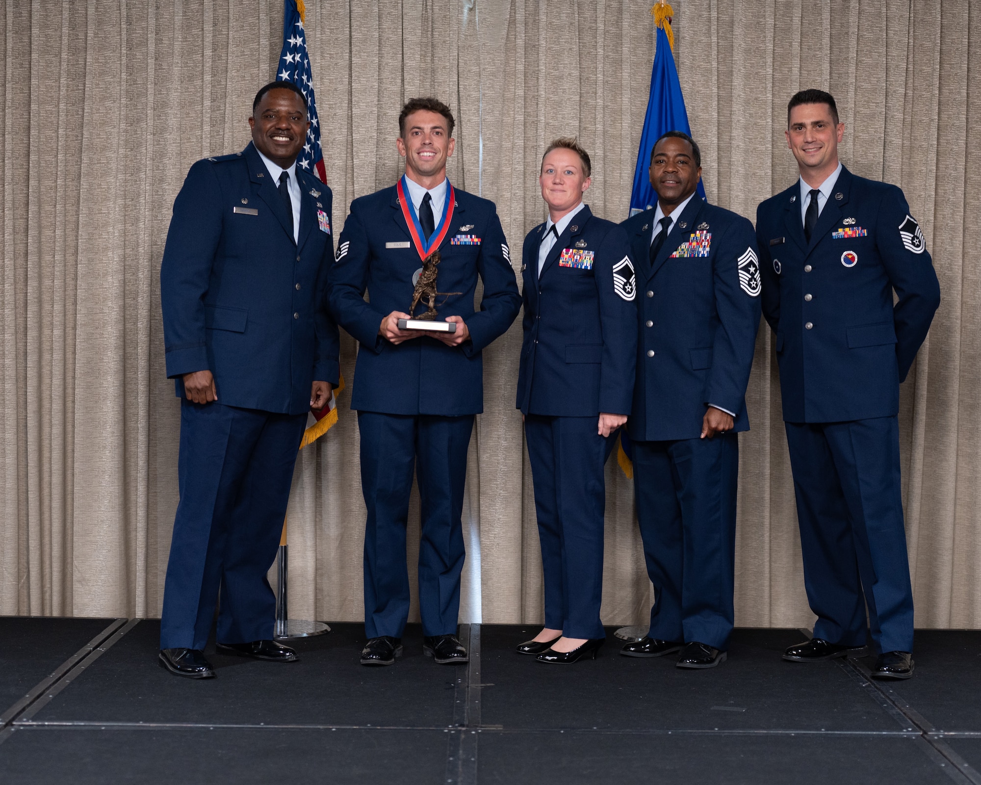 5 airmen pose with Eagle trophy