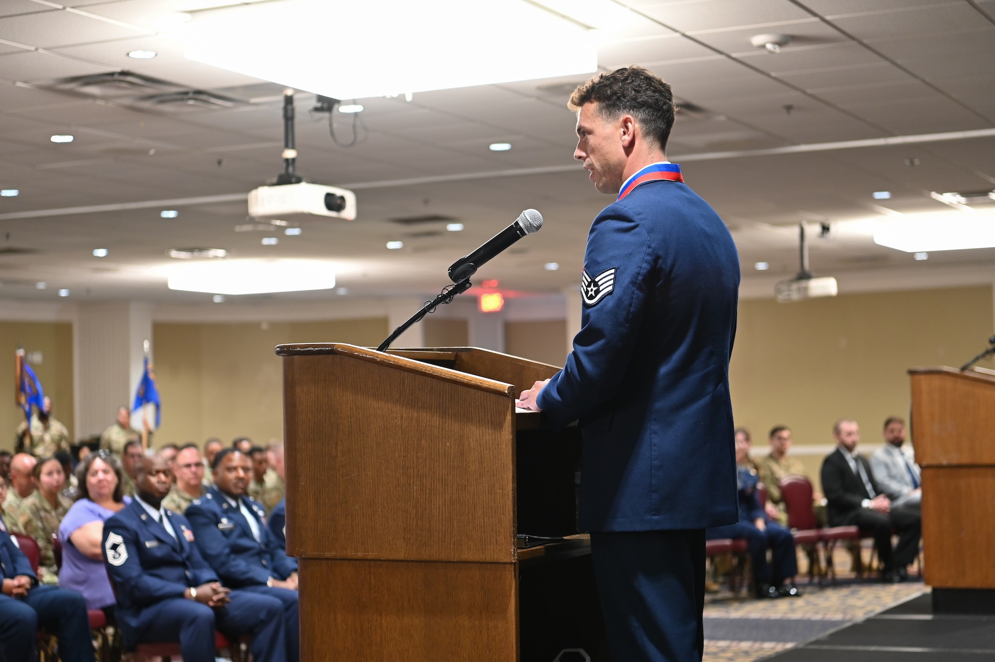 Airman delivers speech on podium