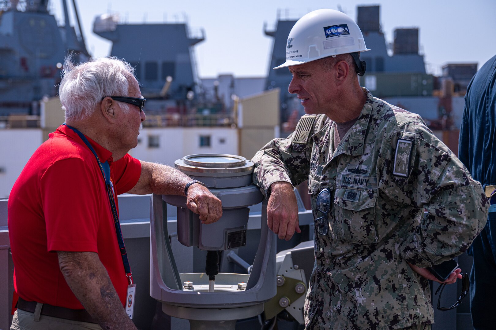 BATH, Maine (July 15, 2025) - U.S. Marine Corps Col. (Ret.) Harvey C. Barnum Jr., speaks to CAPT Jay Young while aboard the Arleigh Burke-class guided-missile destroyer Pre-Commissioning Unit Harvey C. Barnum Jr. (DDG-124) prior to sea trials. The ship is named in honor of Barnum, who received the Medal of Honor for Valor in the Vietnam war. (U.S. Navy Photo by Neil Boorjian)