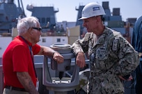 BATH, Maine (July 15, 2025) - U.S. Marine Corps Col. (Ret.) Harvey C. Barnum Jr., speaks to CAPT Jay Young while aboard the Arleigh Burke-class guided-missile destroyer Pre-Commissioning Unit Harvey C. Barnum Jr. (DDG-124) prior to sea trials. The ship is named in honor of Barnum, who received the Medal of Honor for Valor in the Vietnam war. (U.S. Navy Photo by Neil Boorjian)