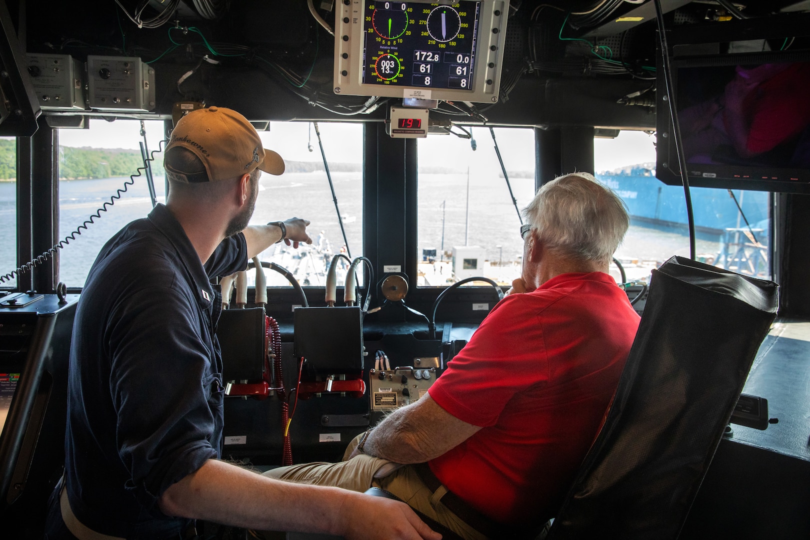 BATH, Maine (July 15, 2025) – Weapons officer, LT Darrell Sands points out something to U.S. Marine Corps Col. (Ret.) Harvey C. Barnum Jr., a Medal of Honor recipient, as he sits on the bridge of the future USS Harvey C. Barnum Jr. (DDG 124) during sea trials. The ship is named in honor of Barnum, who received the Medal of Honor for valor during the Vietnam War. (U.S. Navy photo by Laura Lakeway)