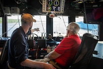 BATH, Maine (July 15, 2025) – Weapons officer, LT Darrell Sands points out something to U.S. Marine Corps Col. (Ret.) Harvey C. Barnum Jr., a Medal of Honor recipient, as he sits on the bridge of the future USS Harvey C. Barnum Jr. (DDG 124) during sea trials. The ship is named in honor of Barnum, who received the Medal of Honor for valor during the Vietnam War. (U.S. Navy photo by Laura Lakeway)