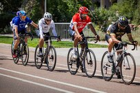 U.S. Army Staff Sgt. Tam Hoang, white jersey, races alongside competitors during the men's upright bicycle road race at the cycling event during the2025 Department of Defense Warrior Games at Colorado College, Colorado Springs Colorado, July 19, 2025.