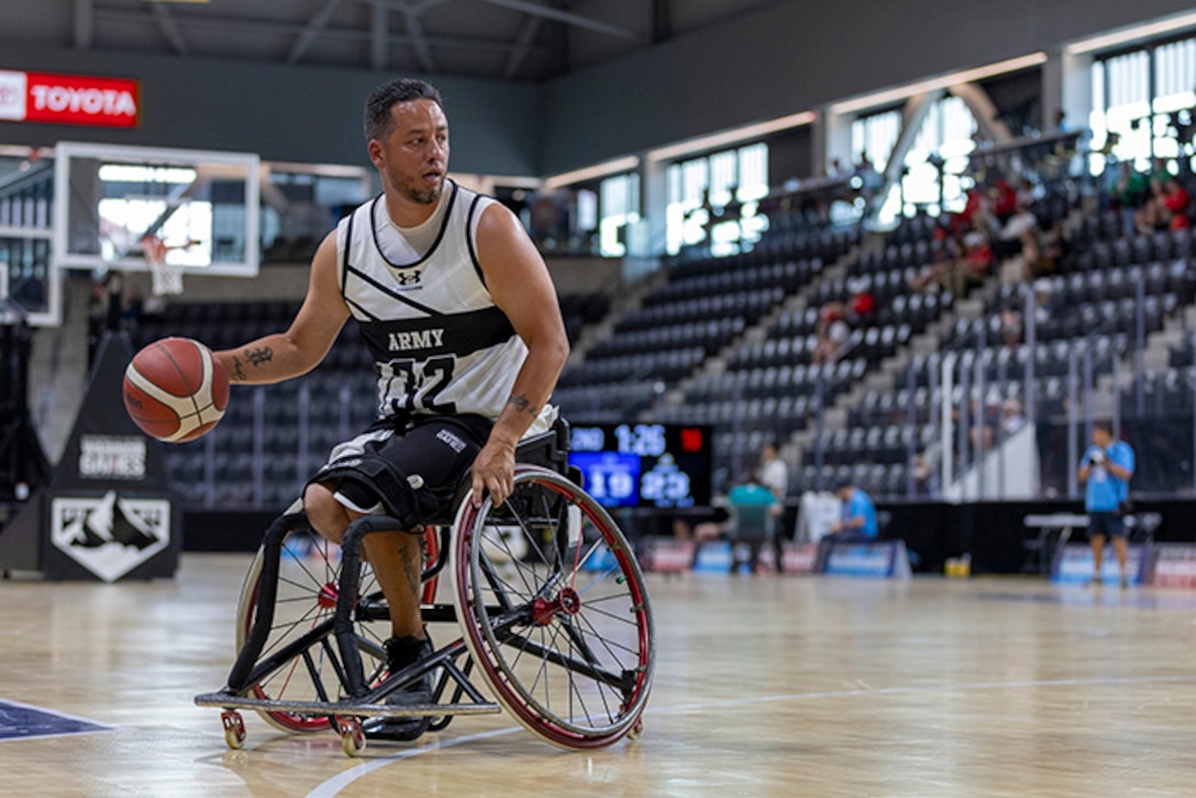 U.S. Army Spc. Anthony Farve looks for open teammates in a wheelchair basketball game during the 2025 Department of Defense Warrior Games at Colorado Springs, Colorado, July 19, 2025.