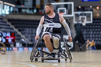 U.S. Army Sgt. 1st Class Adam Proctor looks for an opening in a wheelchair basketball game during the 2025 Department of Defense Warrior Games at Colorado Springs, Colorado, July 19, 2025.