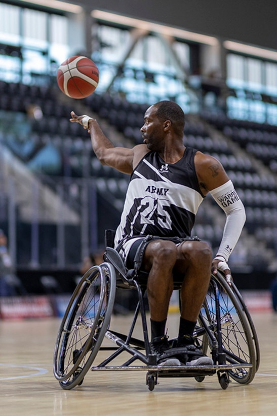 U.S. Army Staff Sgt. Derrick Thompson passes the ball to an open teammate in a wheelchair basketball game during the 2025 Department of Defense Warrior Games at Colorado Springs, Colorado, July 19, 2025.