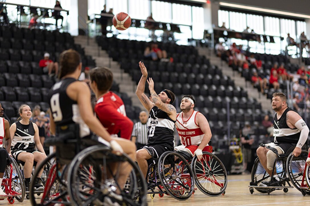 U.S. Army Staff Sgt. John Michael Britton takes a shot in the wheelchair basketball games against Team Marine Corps during the 2025 Department of Defense Warrior Games at Colorado Springs, Colorado, July 19, 2025.