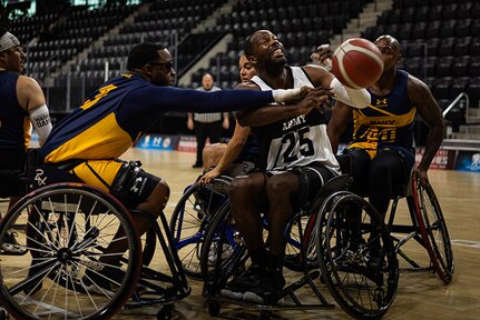 U.S. Army Staff Sgt. Derrick Thompson attempts to regain control of the ball after it was knocked from his hands in the wheelchair basketball game against Team Navy during the 2025 Department of Defense Warrior Games at Colorado Springs Colorado, July 19, 2025.
