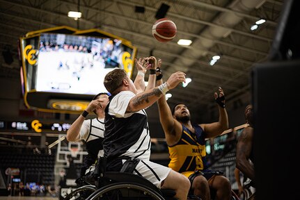 U.S. Army Staff Sgt. Tyler Pollard reaches for a rebound during the wheelchair basketball game against Team Navy during the 2025 Department of Defense Warrior Games at Colorado Springs Colorado, July 19, 2025.