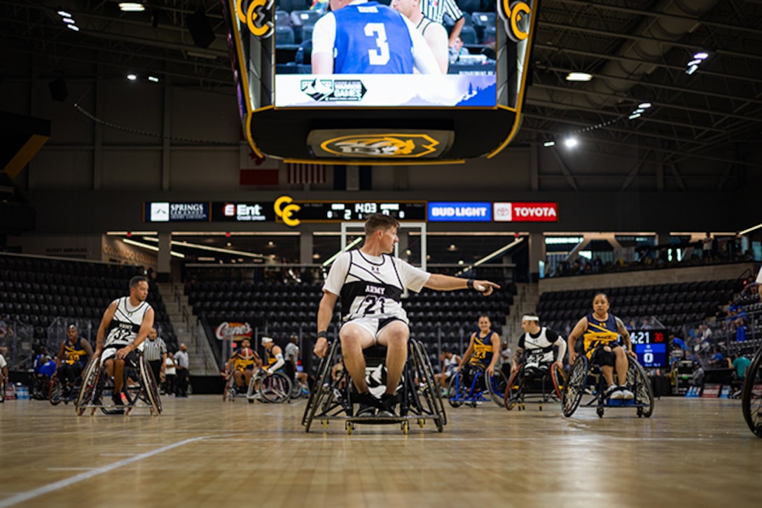 U.S. Army Staff Sgt. Coty Tuck signals for a defender during the wheelchair basketball game against Team Navy during the 2025 Department of Defense Warrior Games at Colorado Springs Colorado, July 19, 2025.