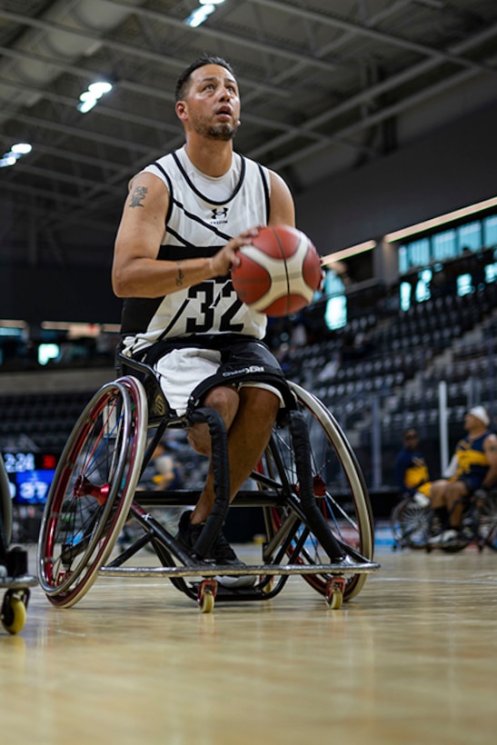 Retired U.S. Army Spc. Anthony Farve goes for a shot during the wheelchair basketball warm ups with Team Navy during the 2025 Department of Defense Warrior Games at Colorado Springs Colorado, July 19, 2025.
