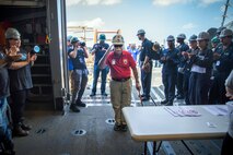 BATH, Maine (July 15, 2025) – U.S. Marine Corps Col. (Ret.) Harvey C. Barnum Jr., a Medal of Honor recipient, is welcomed into the hangar by the crew of the future USS Harvey C. Barnum Jr. (DDG 124) during Alpha Trials. The ship is named in honor of Barnum, who received the Medal of Honor for valor during the Vietnam War. (U.S. Navy photo by Laura Lakeway)