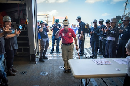 BATH, Maine (July 15, 2025) – U.S. Marine Corps Col. (Ret.) Harvey C. Barnum Jr., a Medal of Honor recipient, is welcomed into the hangar by the crew of the future USS Harvey C. Barnum Jr. (DDG 124) during Alpha Trials. The ship is named in honor of Barnum, who received the Medal of Honor for valor during the Vietnam War. (U.S. Navy photo by Laura Lakeway)