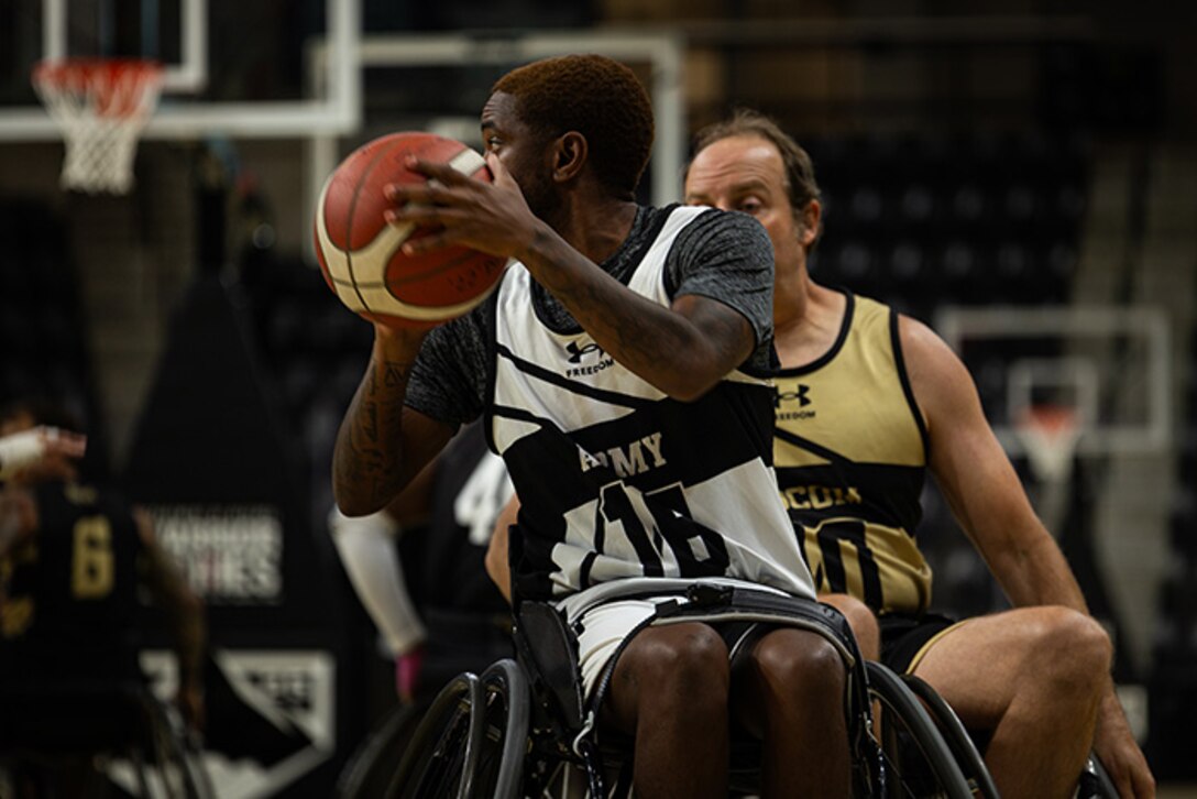 U.S. Army Staff Sgt. Allaijah Churchwell looks to pass the ball during the wheelchair basketball game against Team SOCOM during the 2025 Department of Defense Warrior Games at Colorado Springs Colorado, July 19, 2025.