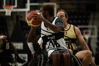 U.S. Army Staff Sgt. Allaijah Churchwell looks to pass the ball during the wheelchair basketball game against Team SOCOM during the 2025 Department of Defense Warrior Games at Colorado Springs Colorado, July 19, 2025.