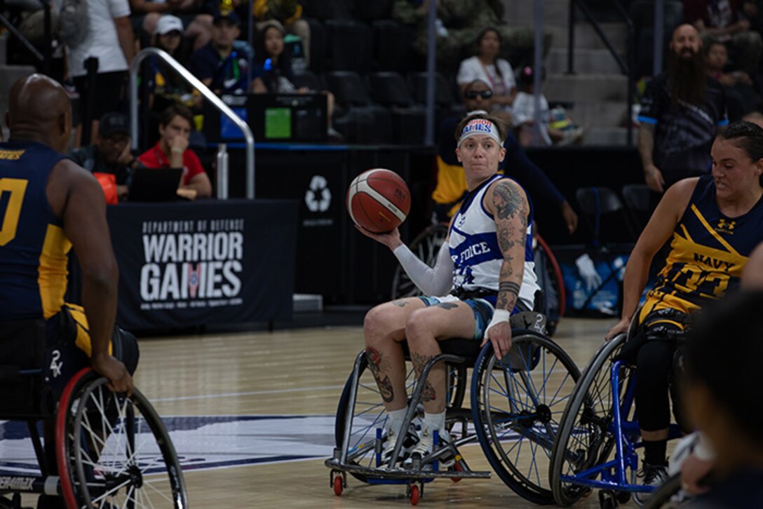 U.S. Air Force Staff Sgt. Allison Smith prepares to pass the ball during the opening round of wheelchair basketball games on July 19, 2025.