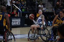U.S. Air Force Staff Sgt. Allison Smith prepares to pass the ball during the opening round of wheelchair basketball games on July 19, 2025.