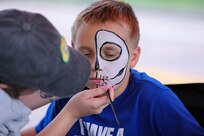 A child has his face painted during the Limitless Lanes event on July 18, 2025, in Colorado Springs, Colorado.
