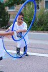 A child maneuvers through a hula hoop during the Limitless Lanes event on July 18, 2025, in Colorado Springs, Colorado.