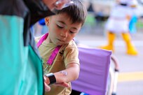 A child inspects his newly painted tattoo during the Limitless Lanes event on July 18, 2025, in Colorado Springs, Colorado.