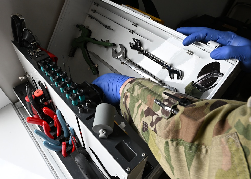 U.S. Air Force Senior Airman Evan William Petrosky, 354th Air Expeditionary Wing aircrew flight equipment technician, grabs tools to fix a flight suit to ensure it is serviceable for flights during exercise Resolute Force Pacific (REFORPAC) 25, July 19, 2025.