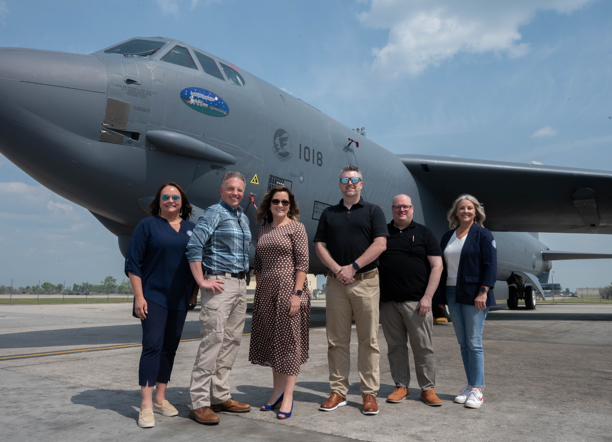 Members of the Association of Defense Communities and Minot Area Chamber Economic Development Corporation pose for a photo in front of a B-52H Stratofortress.
