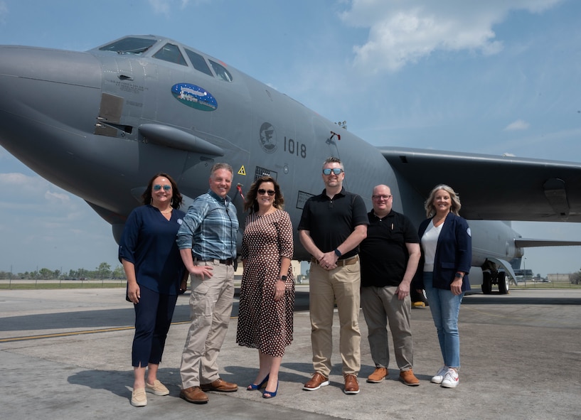 Members of the Association of Defense Communities and Minot Area Chamber Economic Development Corporation pose for a photo in front of a B-52H Stratofortress.