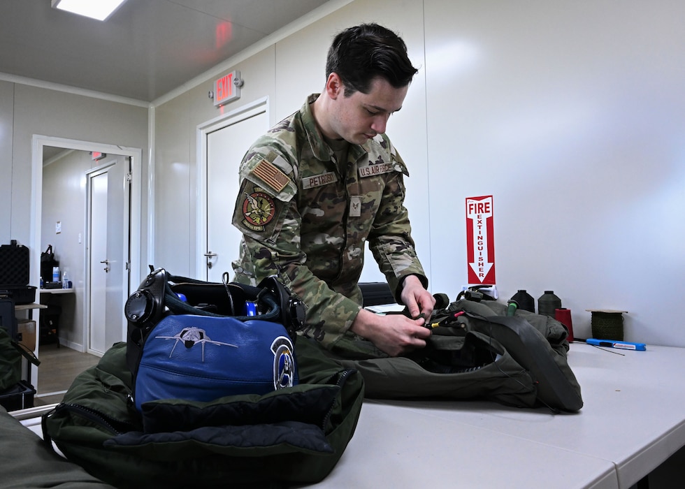U.S. Air Force Senior Airman Evan William Petrosky, 354th Air Expeditionary Wing aircrew flight equipment technician, inspects a flight suit to ensure it is serviceable for flights during exercise Resolute Force Pacific (REFORPAC) 25, July 21, 2025.