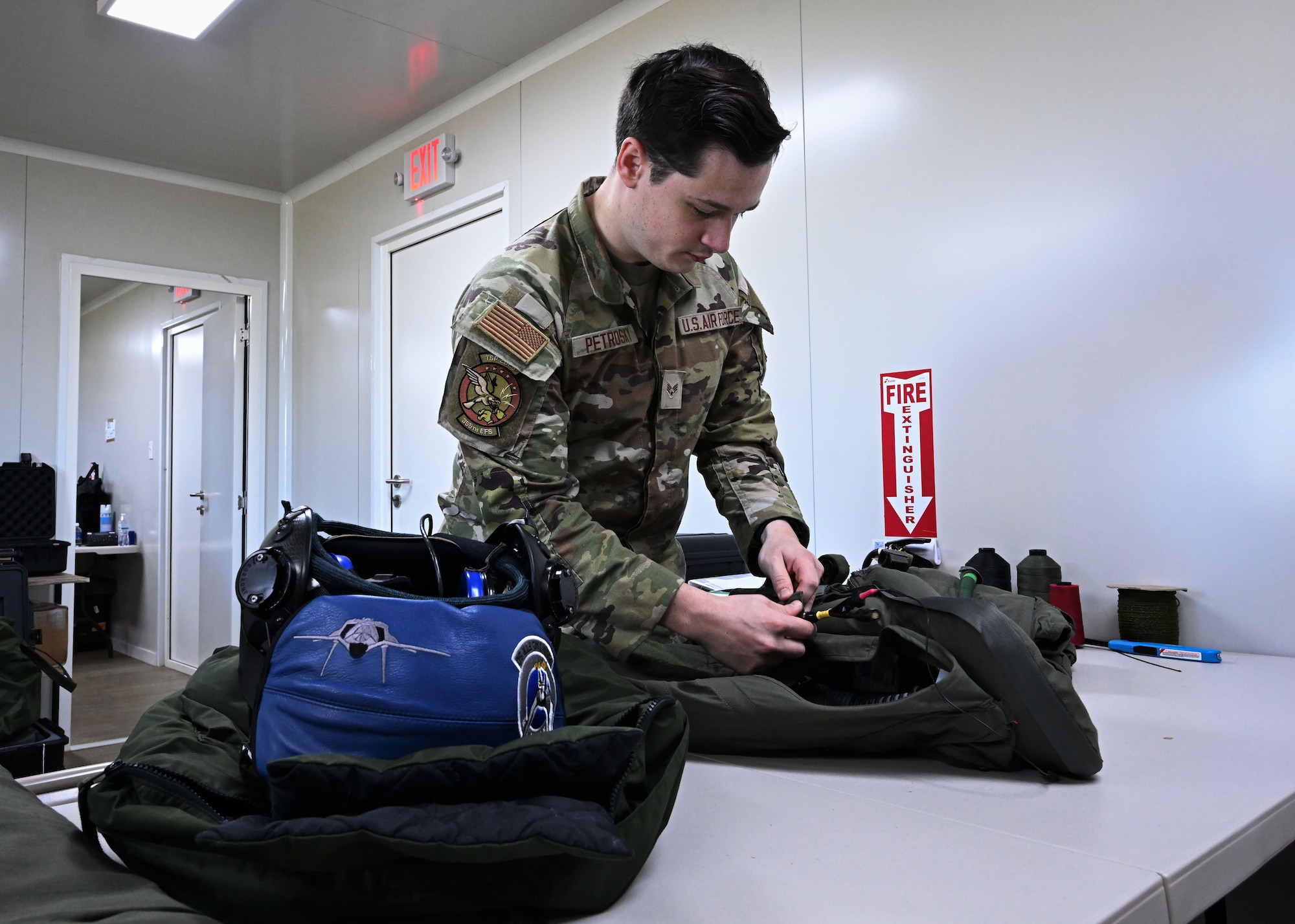 U.S. Air Force Senior Airman Evan William Petrosky, 354th Air Expeditionary Wing aircrew flight equipment technician, inspects a flight suit to ensure it is serviceable for flights during exercise Resolute Force Pacific (REFORPAC) 25, July 21, 2025.