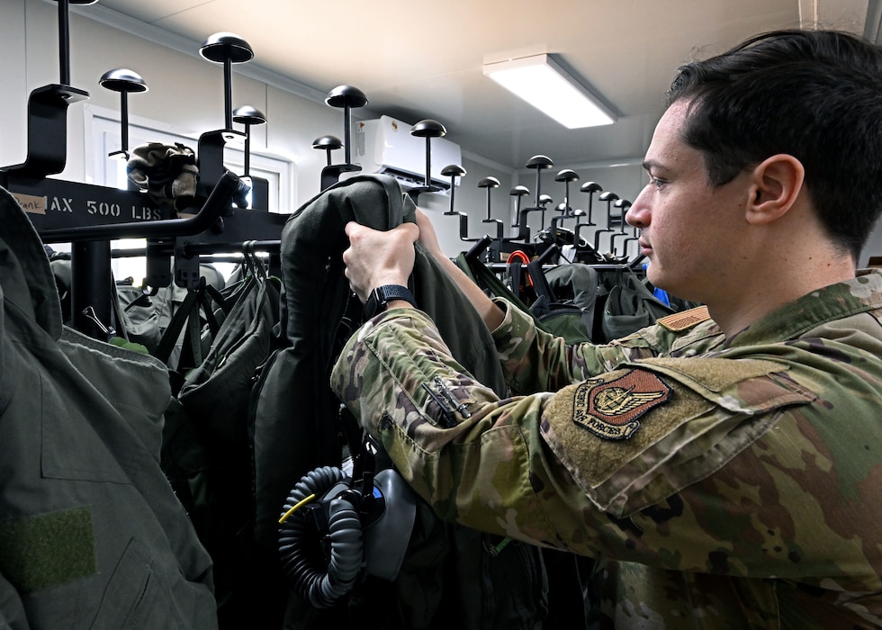 U.S. Air Force Senior Airman Evan William Petrosky, 354th Air Expeditionary Wing aircrew flight equipment technician, takes down gear for an inspection to ensure it is serviceable during exercise Resolute Force Pacific (REFORPAC) 25, July 21, 2025.