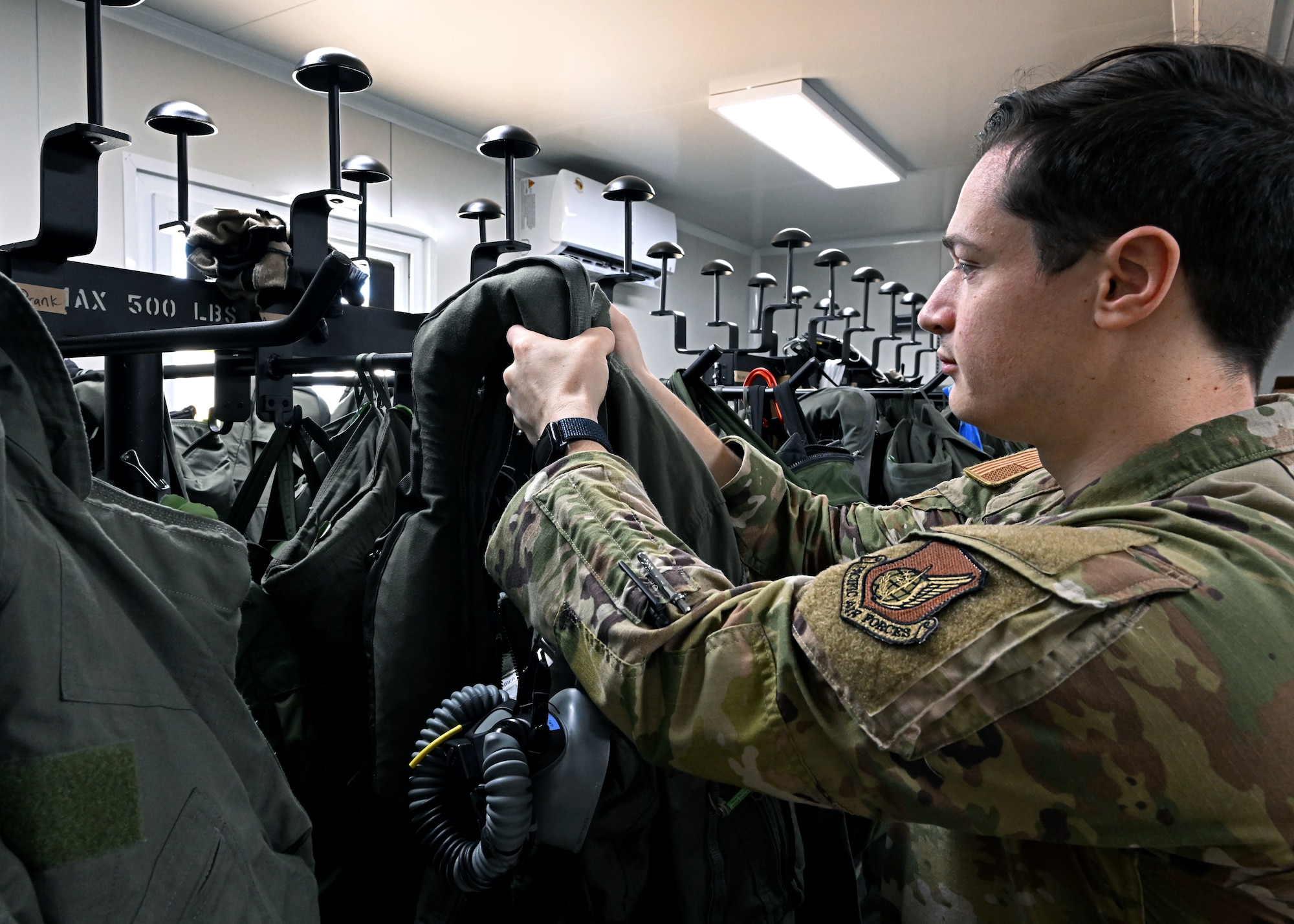 U.S. Air Force Senior Airman Evan William Petrosky, 354th Air Expeditionary Wing aircrew flight equipment technician, takes down gear for an inspection to ensure it is serviceable during exercise Resolute Force Pacific (REFORPAC) 25, July 21, 2025.