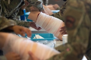 Airmen from the 49th Medical Group train on cleaning and covering wounds during a Medic-X exercise at Holloman Air Force Base, New Mexico, July 16, 2025.