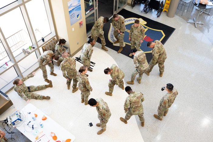 Medics from the 49th Medical Group self-apply turniquets during a Medic-X exercise at Holloman Air Force Base, New Mexico, July 16, 2025.