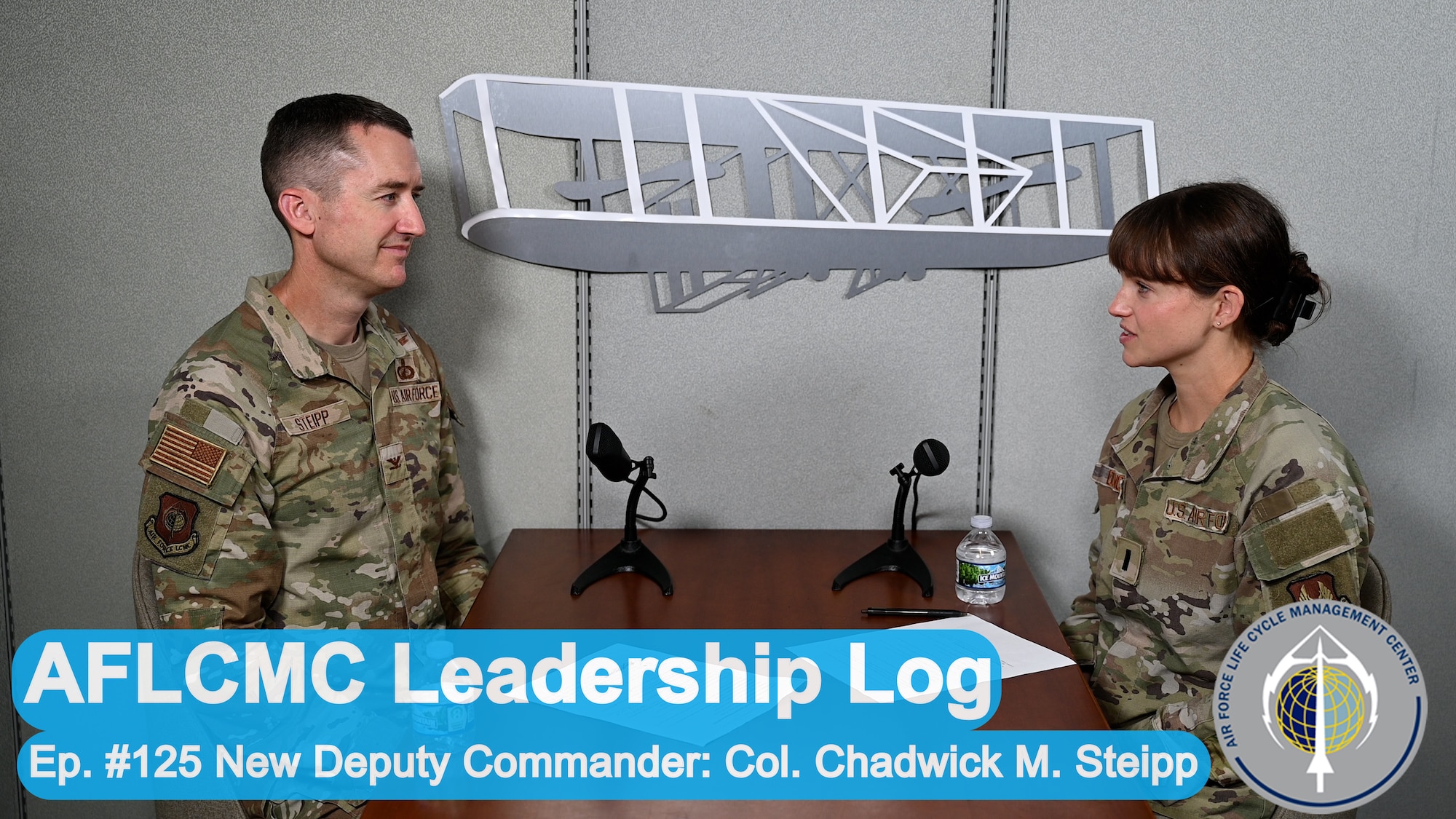Image of two Air Force officers sitting at a table, talking